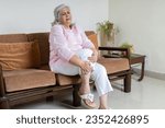 Small photo of Tired, Senior gray haired woman holding her knee suffering from Joint pain