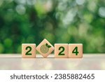 Small photo of 2024 New Year goal for Business plan and development for achieving goals concept.2024 and target icon on a green background.Green business and sustainability investment.