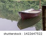 A Chained Rowing Boat Floats On ...