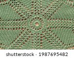 Beautiful crochet closeup doily, green crochet  background