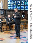 Small photo of Schaerbeek, Brussels / Belgium - 04 26 2019: First alderman Vincent Vanhalewyn speeching to a crowd during the event around the renovation og the Saint Suzanna art deco church