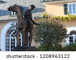 Small photo of Statue of messenger at Schloss Johannisberg in memory of first late harvest of the nobly rotten grapes which became the rule on Castle from then on. Famous courier whose delay led to the Spatlese wine