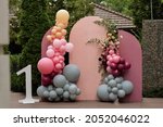 Children's photo zone with a lot of balloons. Decorations for a One year old Girls Birthday party. Concept of children's birthday party. Colourful party