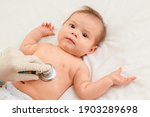 Small photo of Baby auscultation. The doctor listens to the baby's chest with a stethoscope, checking the heartbeat and lungs. The pediatrician examines the baby. Baby health concept