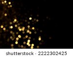Golden blurred bokeh lights on black background. Glitter sparkle stars for celebrate. Overlay for your design
