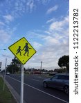 Small photo of Oakleigh, VIC/Australia - June 27 2018: Children crossing sign on street with blue sky