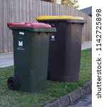 Small photo of Oakleigh, VIC / Australia - July 25 2018: Council municipal weekly and fortnightly general trash and recycle bins on street curb