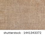 Rural texture of sackcloth. Background of very coarse, rough fabric woven made of flax, jute or hemp. Burlap bag material. Design element. Sacking and bagging  pattern. Top view.