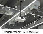 Small photo of A White Overhead Projector and Ceiling Mounted Air Conditioner on ceiling indoors.