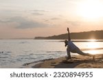 Small photo of Woman praticing yoga at sunset on the beach. Chinese management skill Qi's energy. solo outdoor activities. banner. copy space