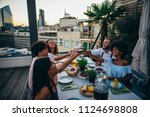 Small photo of Group of friends having fun on the rooftop of a beautiful penthouse