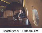 Small photo of Business man flying on a private jet. Working onboard of the airplane. Successfull businessmen lifestyle. Concept about traders, affiliate marketing and sales people