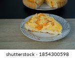 Vanilla pudding cake with tangerines. Plates on a wooden table.