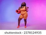 Small photo of Active young voluptuous woman in sportswear carrying exercise mat and smiling on pink background