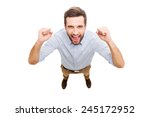 Everyday winner. Top view of happy young man expressing positivity and gesturing while standing isolated on white background