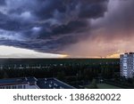 Small photo of huge thundercloud on the outskirts of the city before the rain - image