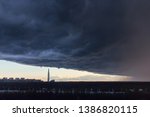 Small photo of huge thundercloud on the outskirts of the city before the rain - image