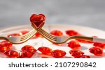 Small photo of Banner. Heart on a fork close-up. Festive table setting. The concept of a holiday for cafes and restaurants. valentine's day. A copy of the space for the text.