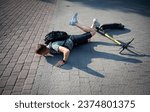 Small photo of Careless man felt down from electric scooter. Young male lying on back after falling from his vehicle. Mused male collided with a car and hurted his back. Ivano-frankivsk, Ukraine - 09.07.2023.