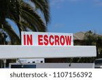 Small photo of Close up of a sign "in Escrow" on a home sold in San Diego County, California