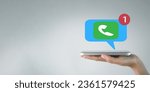 Small photo of Communication, missed call,reminder,incoming message concept.,Hand holding smartphone with missed call notification icon over white background idea for business,technology.