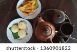 Small photo of teh poci, jadah bakar dan pisang goreng or black tea in the clay pot with misbegotten fuel and fried banana is javanese traditional food and drink