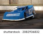 Small photo of Middletown, NY, USA - August 19, 2021: Short track racer Pancho Lawler hustles his Dirt Late Model stock car around the dirt track at New York's Orange County Fair Speedway.