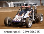 Small photo of Indianapolis, IN, USA - May 23, 2019: Race driver Jason McDougal slides his USAC Silver Crown race car through a turn on the Indiana State Fairgrounds mile. Car is slightly blurred to show speed.