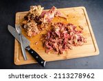 Removing Meat from a Boiled Ham Bone: Using a chef's knife and fork to remove the meat from a hambone