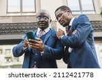 Meeting of two partners black african american businessman in suits and glasses outdoors