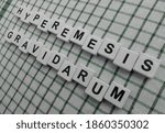 Small photo of Hyperemesis Gravidarum, word cube with background.