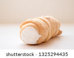 A kremrole or cream roll. A traditional pastry dessert tube filled with cream or meringue and served in central Europe, Czechia, Slovakia and Austria
