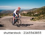 Small photo of Speloncato, Corsica, France - 7th June 2022: Maximilien Couvreur competes in the 2022 BikingMan Corsica race as he tackles the 1100m Col de Battaglia above the village of Speloncato