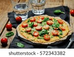 Cauliflower pizza crust with tomato and spinach. toning. selective focus