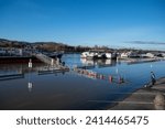 Small photo of Boats and extempore bridge at Carl Lutz Quay in Budapest, Hungary, during the flooding of Danube River - December 27, 2023
