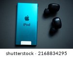 Small photo of KYIV, UKRAINE - JUNE 15, 2022: Apple iPod Nano 7 Gen with headphones on a gray background