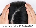 Small photo of Cropped view of woman top's head with part of her thin hair, she had hair loss problem. Female pattern hair loss can progress from a widening part to overall thinning.