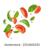 Small photo of Flying ingredients of tomatoes, basil, pepper on white background. Italian food