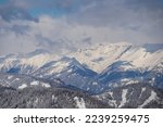 Panoramic view of the snowcapped mountain ranges of High Tauern and Nock Mountains seen from Kobesnock near Bad Bleiberg, Carinthia, Austria, Europe. Winter wonderland landscape in Austrian Alps