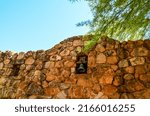Small photo of Superior, AZ, USA - May 2022: Mission style Spanish bell in a stone wall of the Smith building greenhouse at Boyce Thompson Arboretum