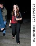 Small photo of Los Angeles, CA, USA, 06/20/2007 Alanis Morissette and about in black pants carrying a black handbag.