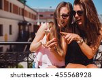 young pretty woman posing in the street with phone, outdoor portrait, hipster girls, sisters, chic, tablet, internet, using smartphone, close-up fashion model, post in instagram, facebook,selfie, USA