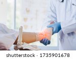 Small photo of Close-up of pictures of a male orthopedic doctor or orthopedic doctor Wear a medical mask and medical gloves. Going to analyze the cause of ankle bone degeneration In his office at the hospital