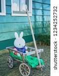 Small photo of Amsterdam, the Netherlands - FEBRUARY 8, 2018: A white Miffy sitting in a wood trolley.