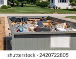 Garbage, trash or waste dumpster full of household junk. House cleaning, declutter and hoarding concept.