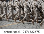 Small photo of Close-up of soldiers legs dressed in army camouflage.A straight line of boots on the icy parade ground.Concept: military men.Russia