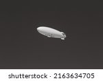 Small photo of Black and white detail of an unmarked or blank blimp. A white airship against a clear sky. Use for advertising, customizable and room for copy and or text.