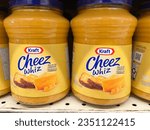 Small photo of Edmonton, Canada - August 17, 2023: Jars of Kraft Cheez Whiz on display on a store shelf