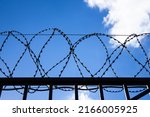 The barbed wire on a high fence ...