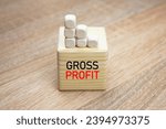 Small photo of Gross profit text on the cube. Gross profit acronym, financial concept.
